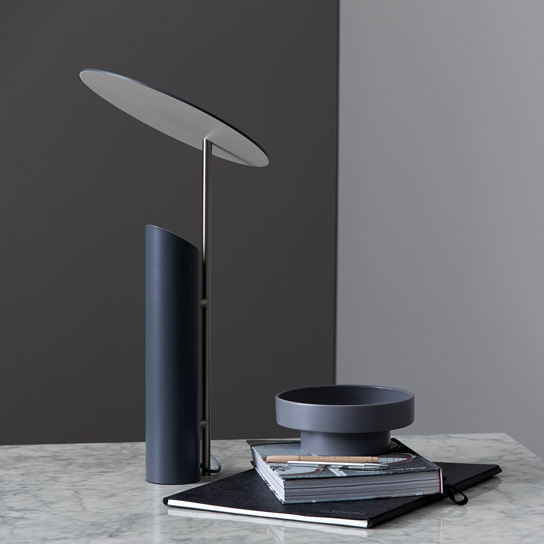 Modern desk lamp with sleek black and gray colors, featuring smooth, minimalist patterns and clean lines.