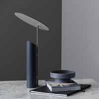 Modern desk lamp with sleek black and gray colors, featuring smooth, minimalist patterns and clean lines.