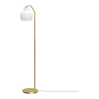 Gold floor lamp with a white shade on a white background