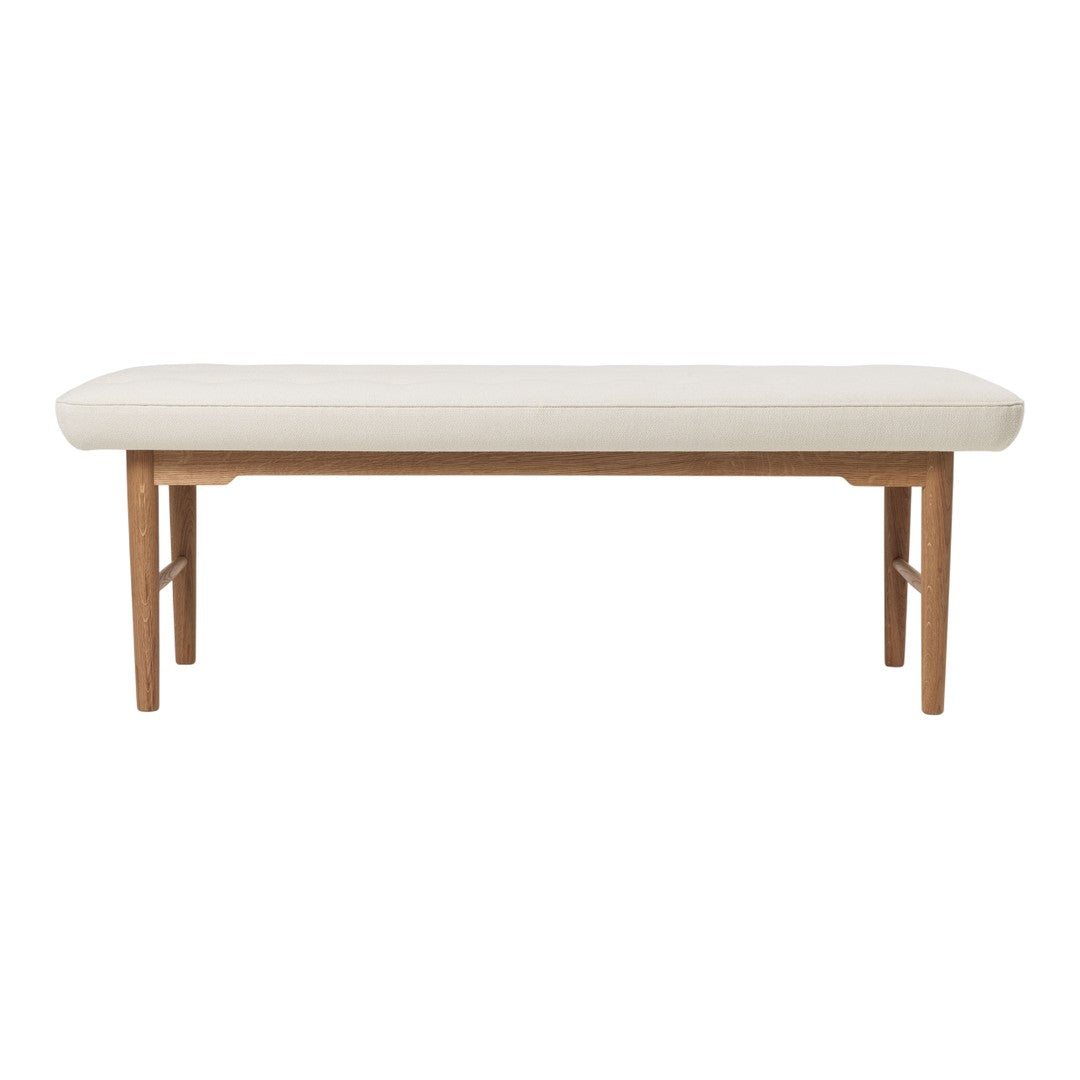 Light beige upholstered bench with a smooth surface and natural wood legs, featuring a simple modern design.