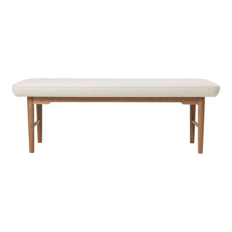 Light beige upholstered bench with a smooth surface and natural wood legs, featuring a simple modern design.