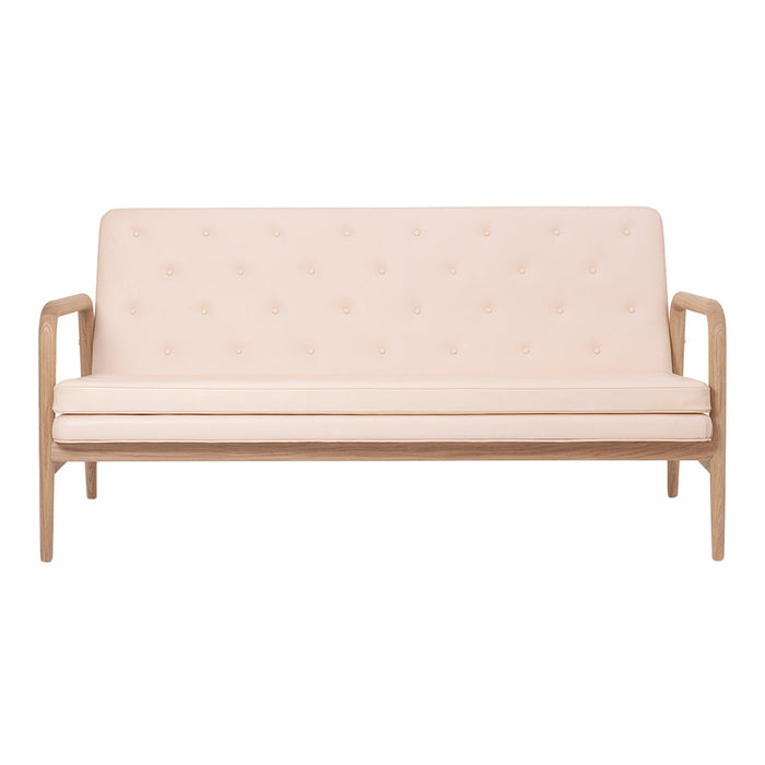 Light pink upholstered sofa with button tufting and natural wood arms, offering a modern and simple design.