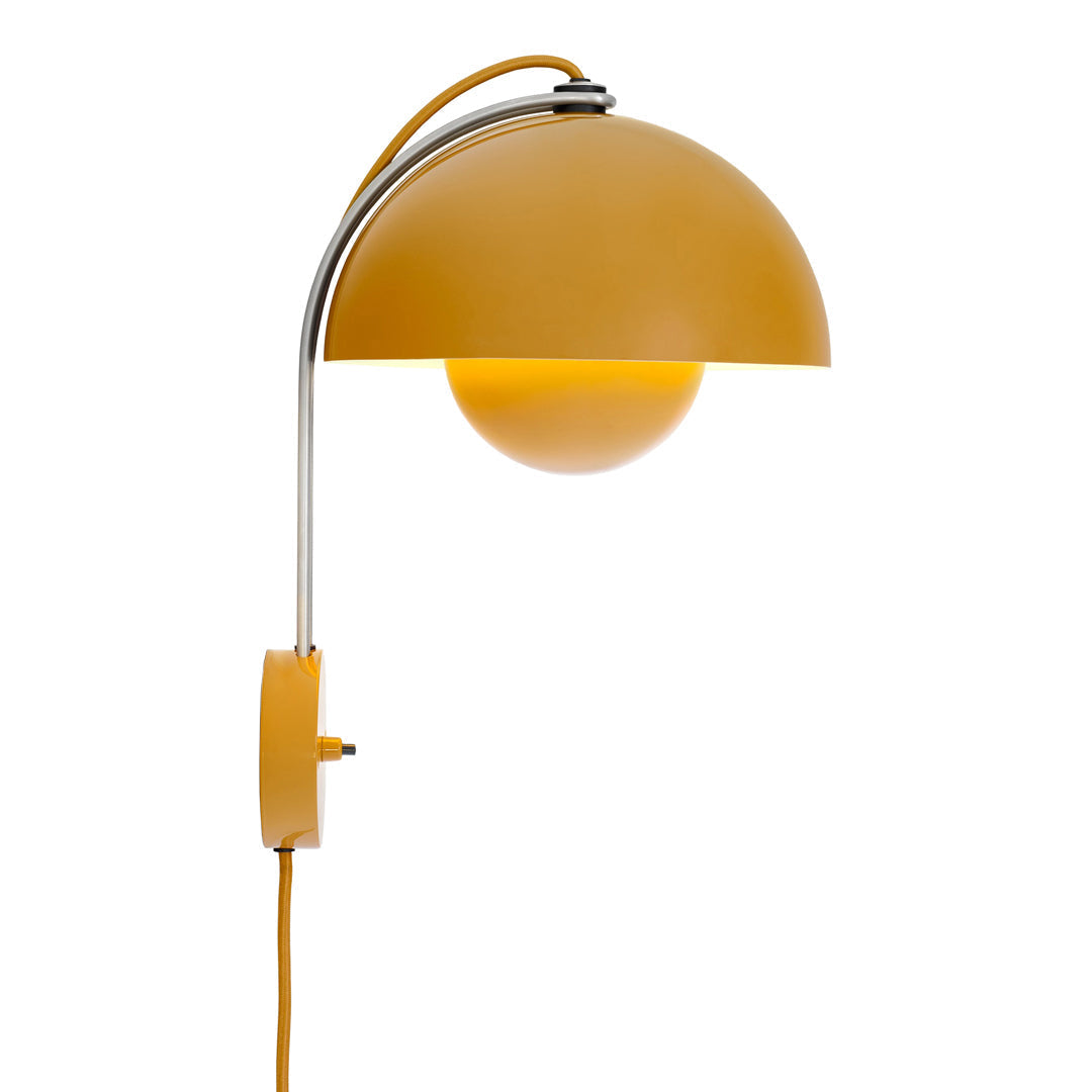 Sleek yellow dome wall lamp with a chrome arm, featuring a round white bulb and matching yellow cord.