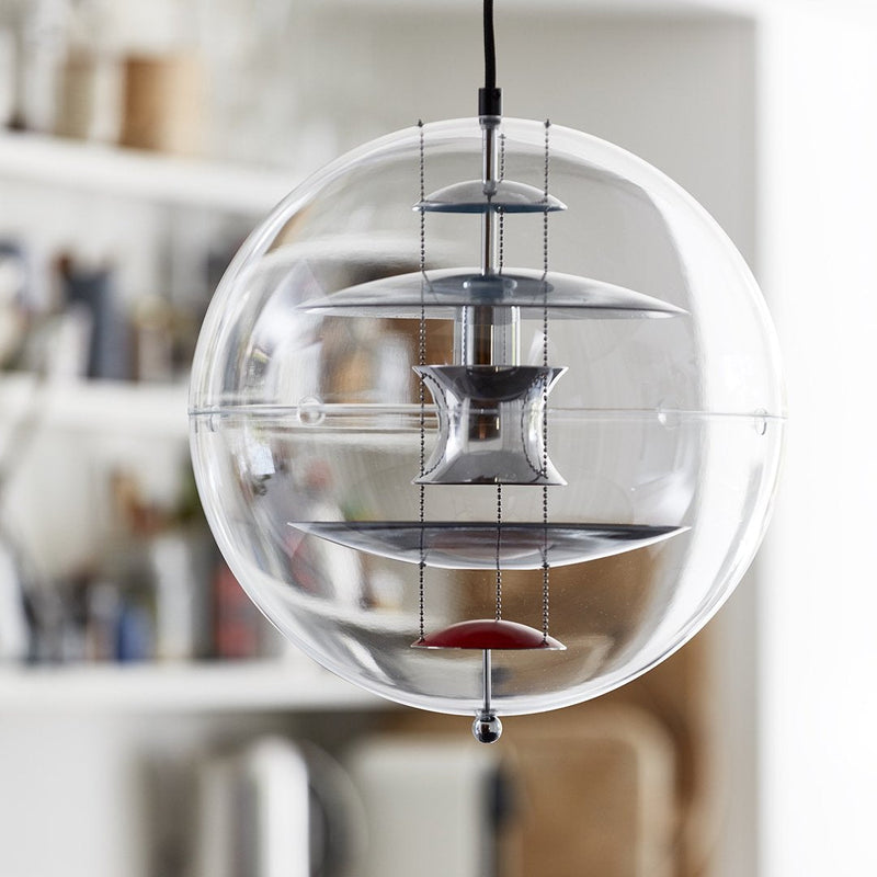Clear glass orb pendant light with metallic accents in silver and vibrant red, showcasing a modern, minimalist design.