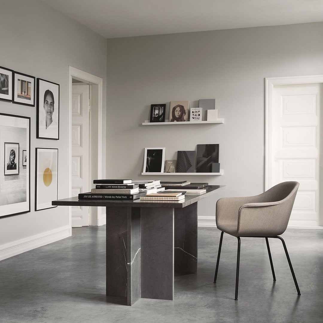 Modern gray and beige office with marble table and muted wall art, featuring clean lines and minimalistic patterns.