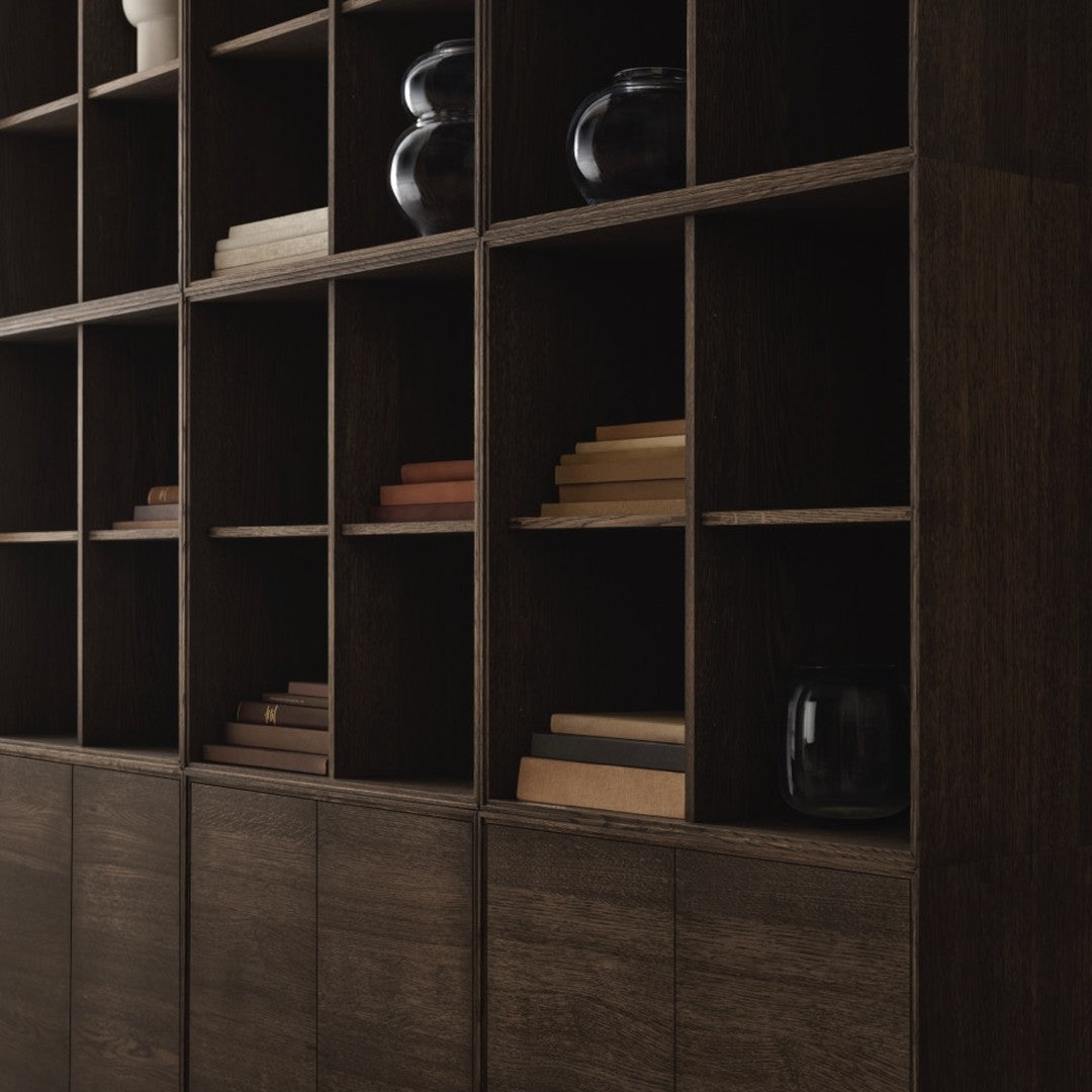Dark wood bookshelf with geometric patterns, featuring black vases and warm wooden shelves. Elegant and modern design.