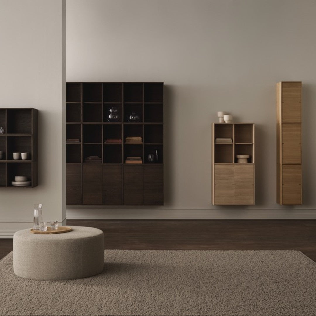 Modern wooden furniture in dark and light tones with minimalist design on a neutral gray wall backdrop.