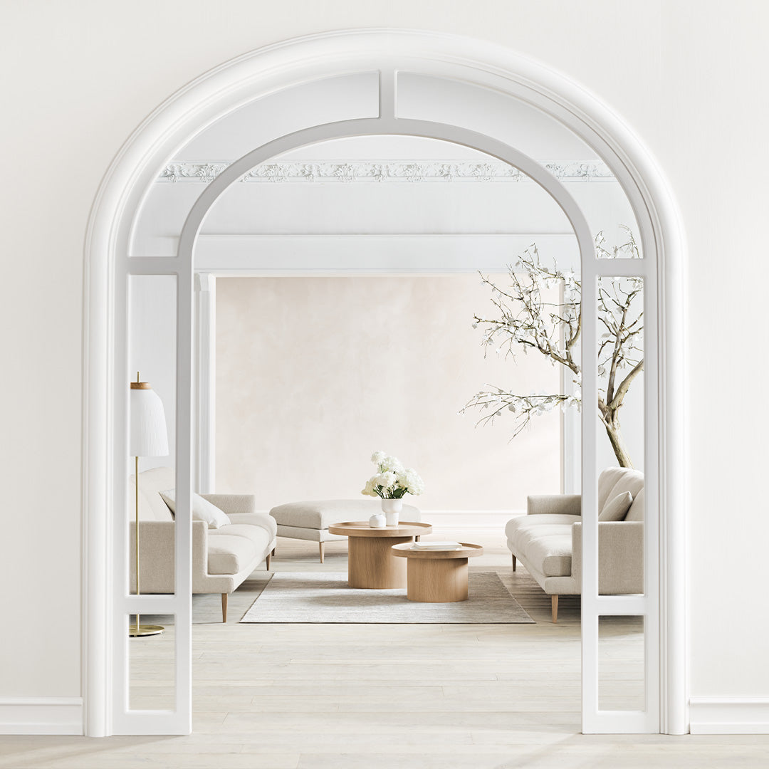 Arched white frame with neutral-toned walls and soft beige furniture, showcasing a minimalist, modern interior.