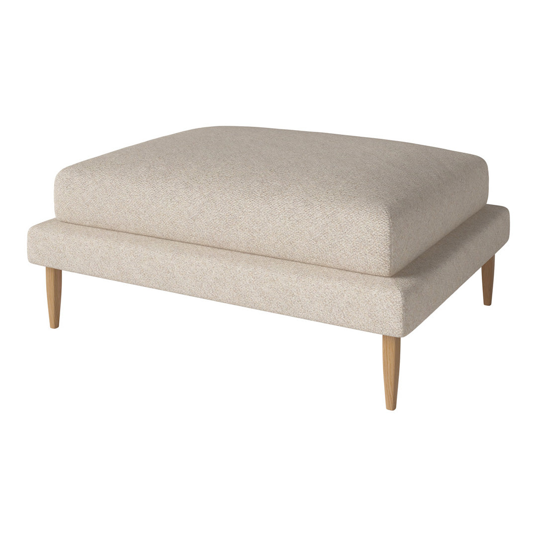 Beige upholstered ottoman with a smooth texture and light wood legs, perfect for modern decor.
