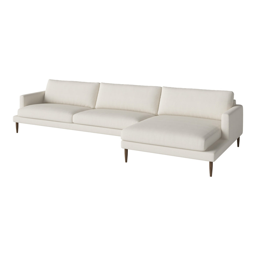 Modern white sectional sofa with clean lines and minimalistic design, featuring soft upholstery and natural wood legs.