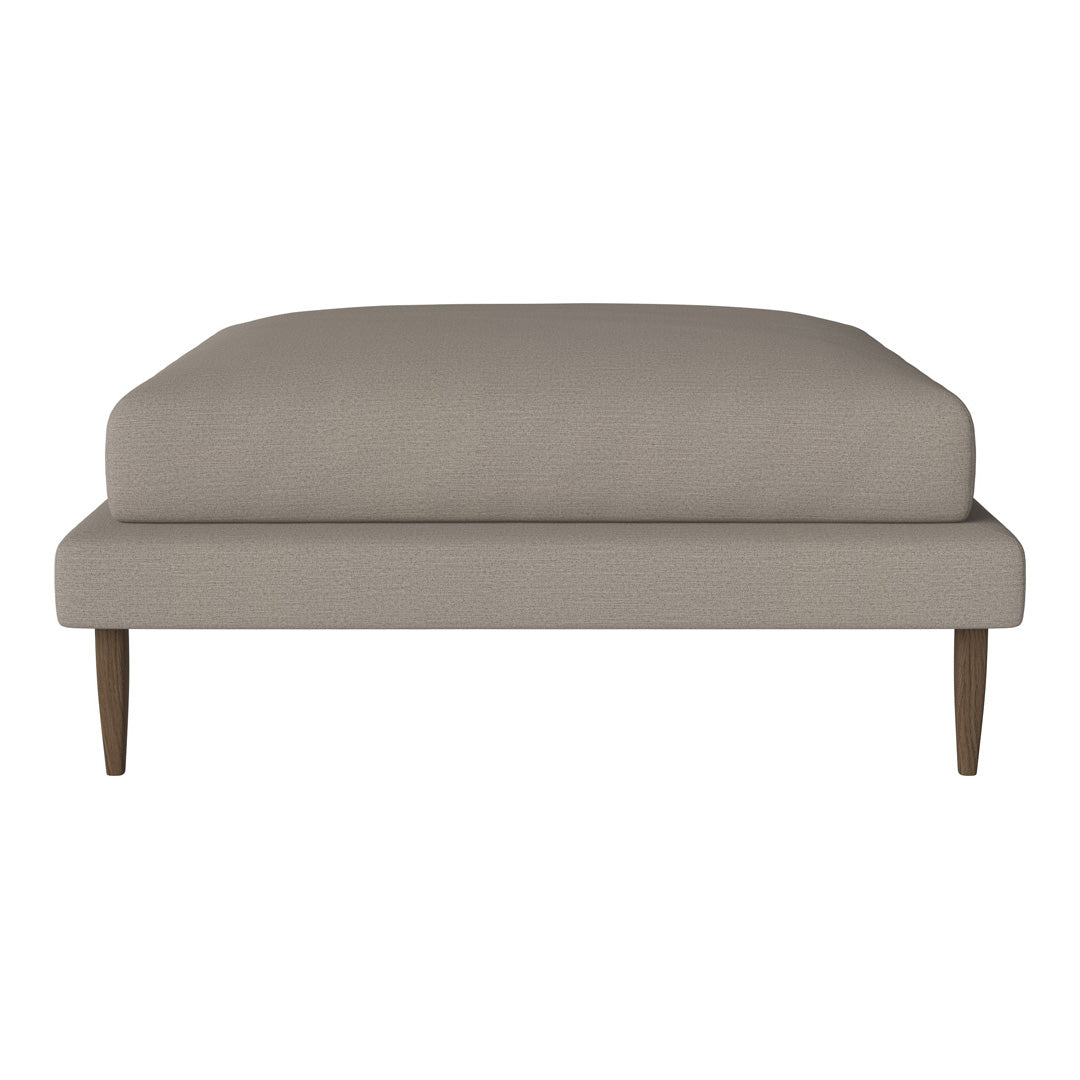 Solid taupe cushion with smooth texture on wooden legs, ideal for modern and minimalist decor.