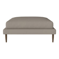 Solid taupe cushion with smooth texture on wooden legs, ideal for modern and minimalist decor.