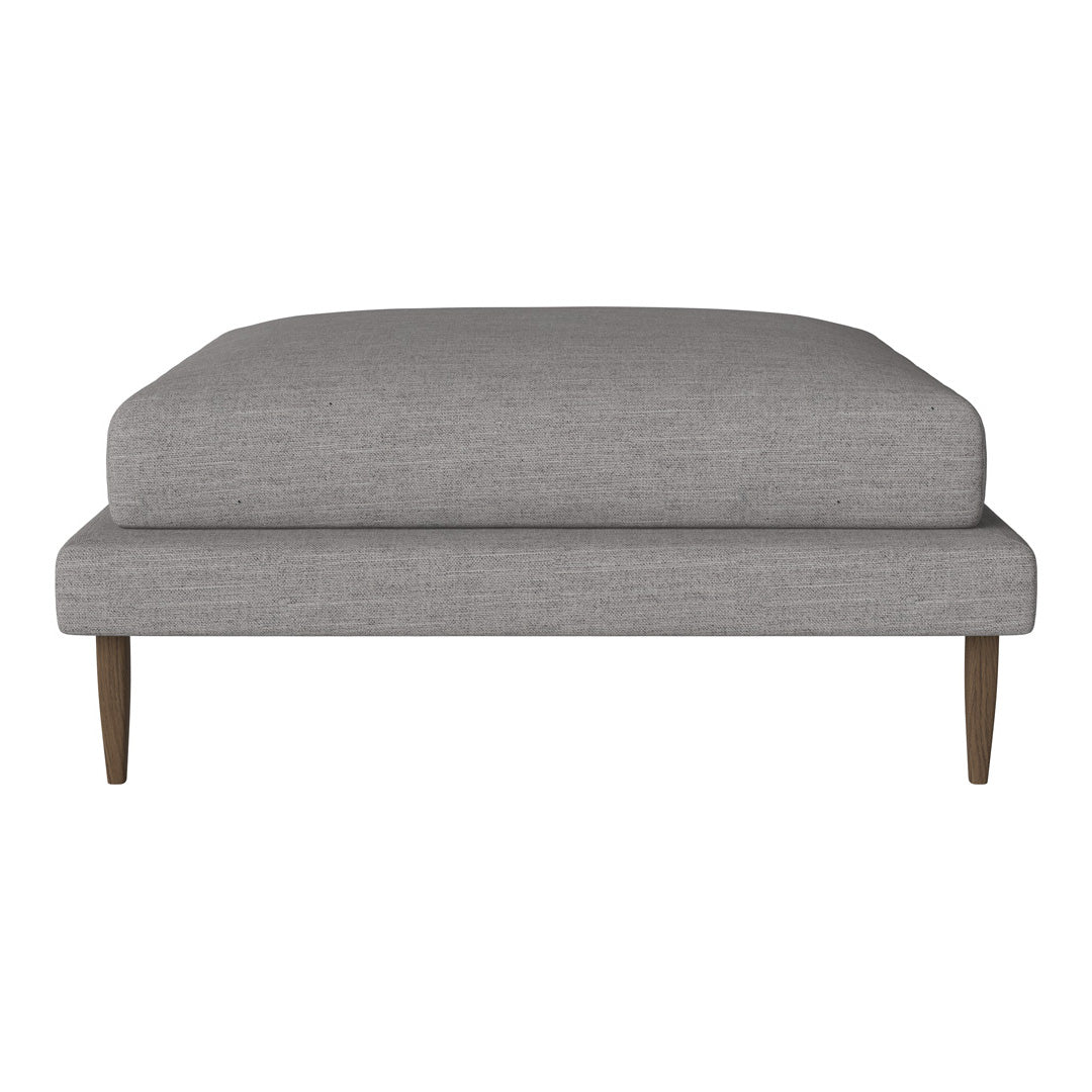 Gray upholstered ottoman with a sleek, modern design and wooden legs, perfect for contemporary home decor.