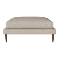 Beige upholstered ottoman with a smooth fabric finish and tapered wooden legs. Simple, modern design.