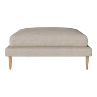 Beige upholstered ottoman with minimalist design and light wooden legs, perfect for modern décor.