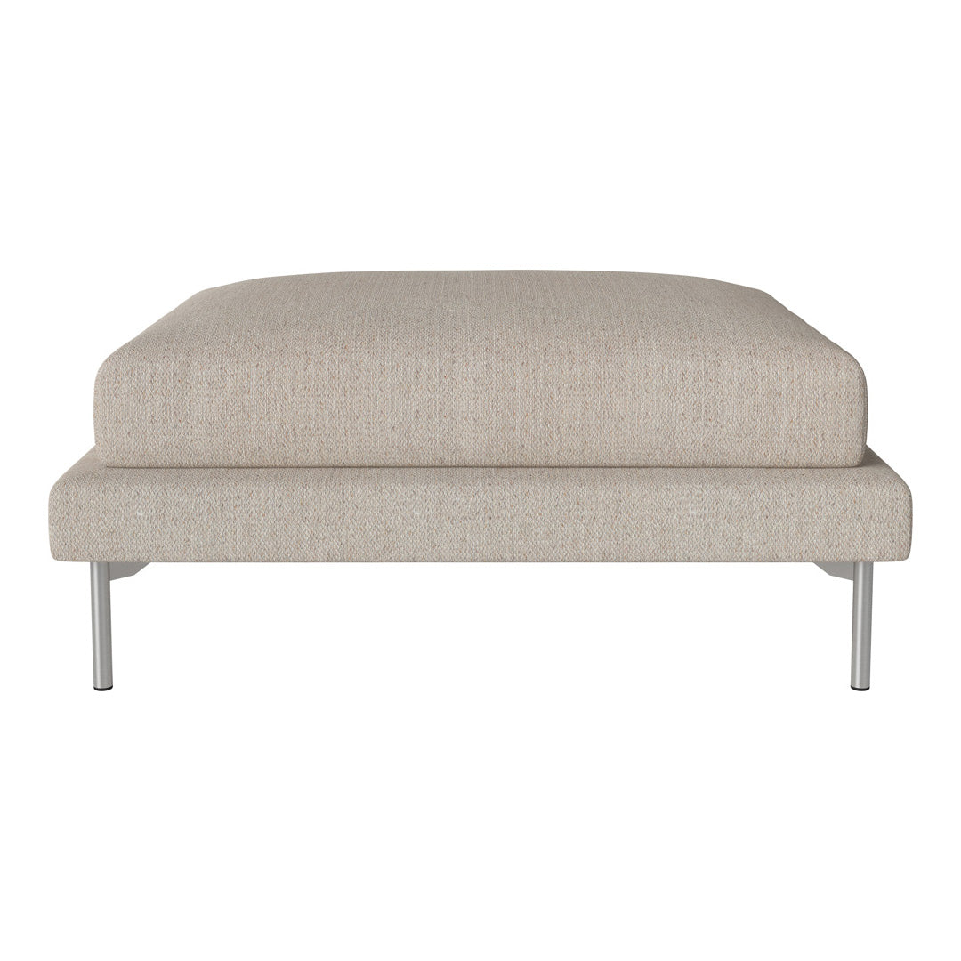 Beige fabric ottoman with a smooth texture and minimalist design, supported by sleek silver legs.