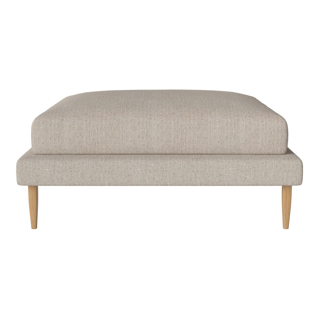 Beige upholstered ottoman with a textured fabric and natural wood legs, featuring a minimalist, modern design.