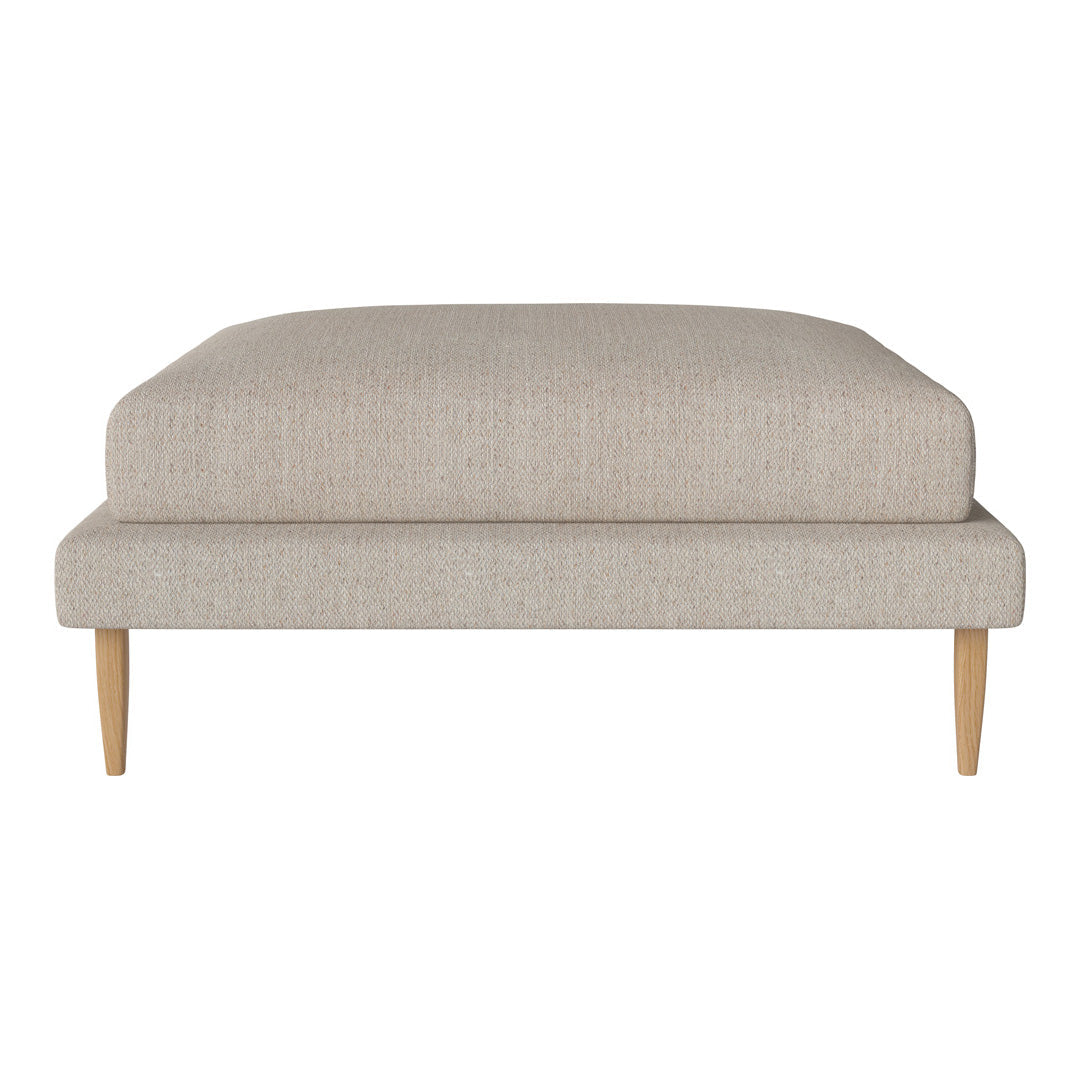 Beige upholstered ottoman with a textured fabric and natural wood legs, featuring a minimalist, modern design.