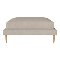 Beige upholstered ottoman with a textured fabric and natural wood legs, featuring a minimalist, modern design.