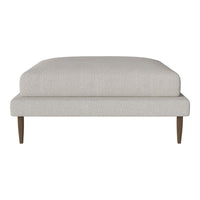 Light gray upholstered ottoman with clean lines and wooden legs, featuring a minimalist design. Ideal for modern spaces.
