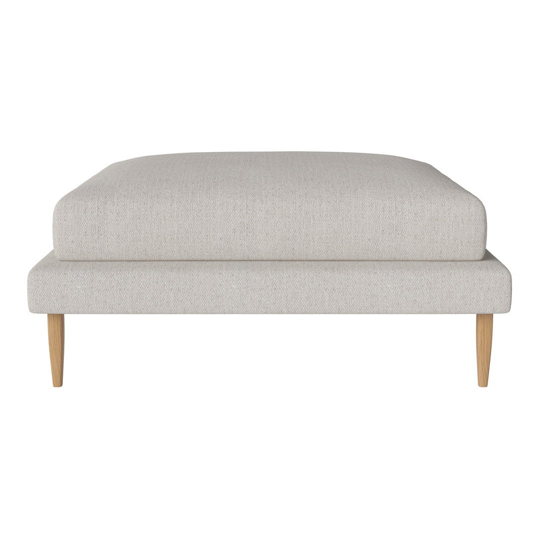 Light beige upholstered ottoman with a smooth texture and natural wooden legs, perfect for modern interiors.