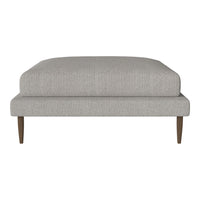 Light gray upholstery ottoman with a simple, textured fabric and wooden legs, perfect for modern decor.