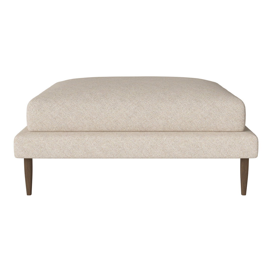 Beige upholstered ottoman with a clean, minimalist design and tapered wooden legs. Suitable for modern decor.