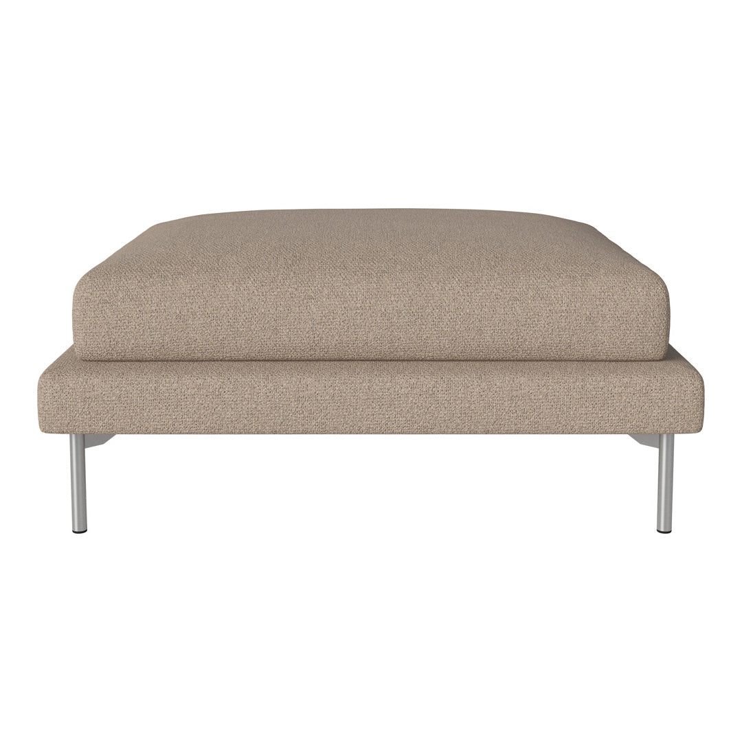 Beige upholstered ottoman with smooth texture and modern silver legs, ideal for contemporary decor.