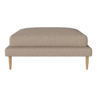Beige upholstered ottoman with a smooth fabric texture and natural wooden legs. Ideal for modern living spaces.