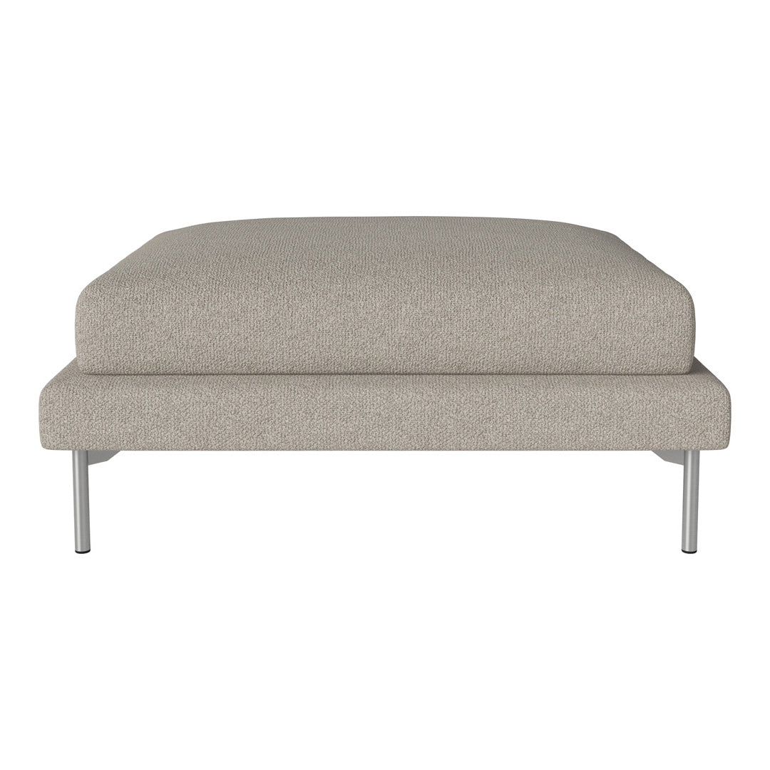Beige upholstered ottoman with a smooth, minimalist design and silver metal legs. Ideal for modern decor.