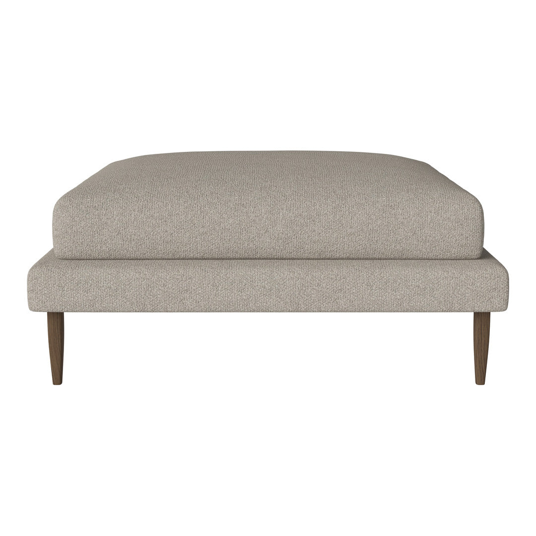 Neutral beige ottoman with a smooth textured fabric and clean, minimalist design. Wood legs add a subtle contrast.