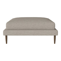Neutral beige ottoman with a smooth textured fabric and clean, minimalist design. Wood legs add a subtle contrast.