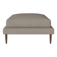 Beige upholstery with a smooth texture, featuring a minimalist design and contrasting wooden legs. Perfect for modern decor.