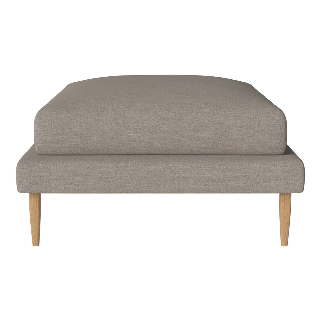 Soft grey upholstered ottoman with a textured finish and light wooden legs. Simple, modern design for versatile decor.