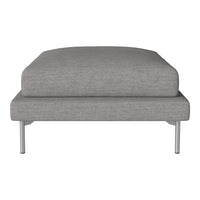 Gray upholstered ottoman with a sleek, modern design and minimalist silver legs. Perfect for contemporary interiors.