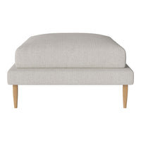 Light gray upholstered ottoman with minimalist design and natural wood legs. Perfect for modern decor.