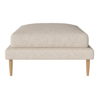Light beige upholstered ottoman with a smooth texture and minimalistic design, featuring natural wood legs.