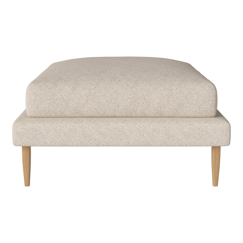 Light beige upholstered ottoman with a smooth texture and minimalistic design, featuring natural wood legs.