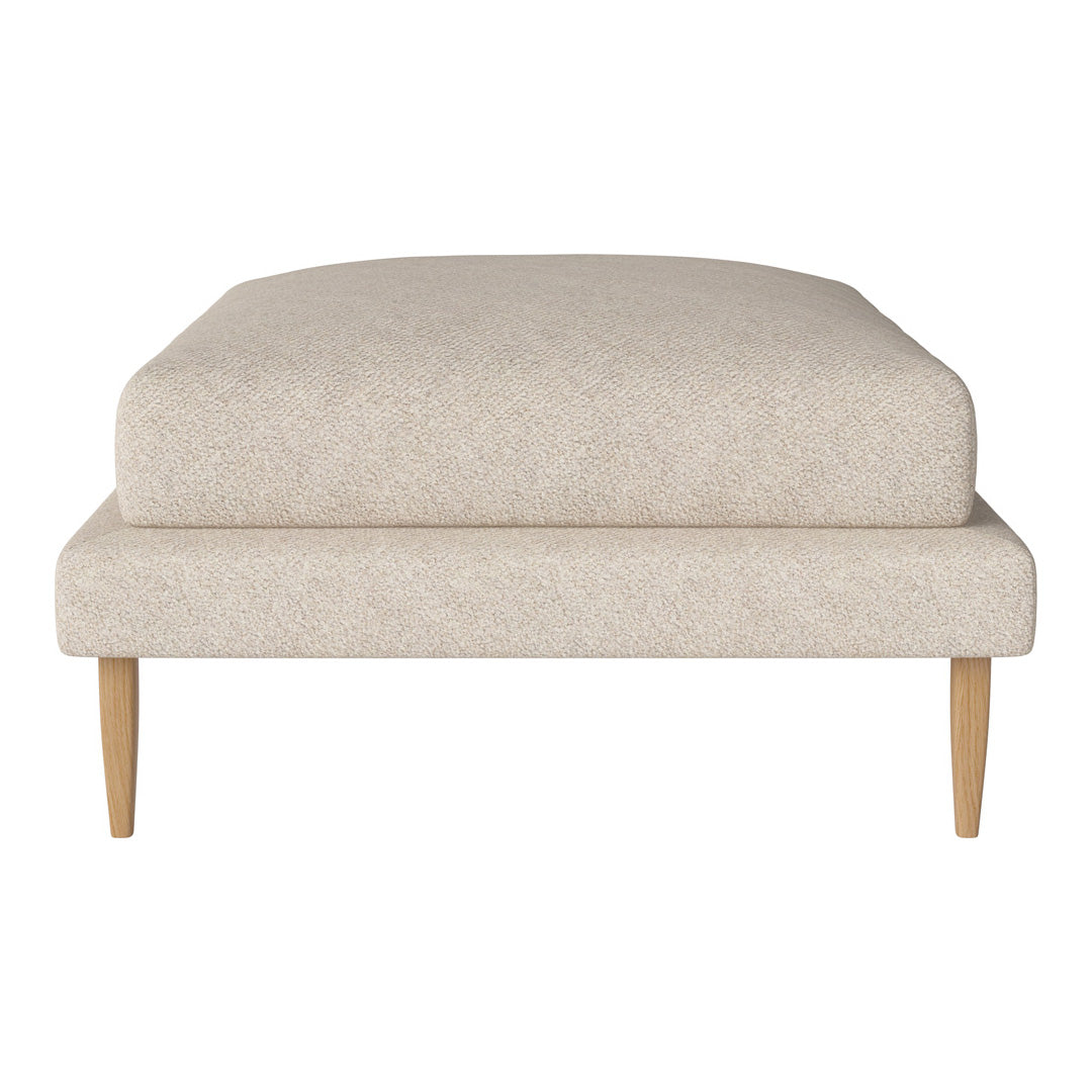 Light beige upholstered ottoman with a smooth texture and minimalistic design, featuring natural wood legs.