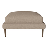 Beige upholstered ottoman with a smooth texture and wooden legs, perfect for contemporary decor.
