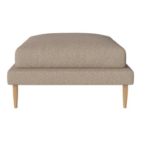 Neutral beige ottoman featuring a smooth fabric texture and sleek wooden legs, perfect for modern decor.