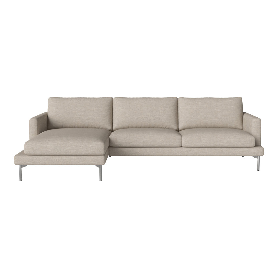 Beige sectional sofa with a smooth texture and clean lines, featuring minimalistic design and silver legs.