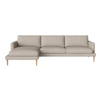 Light beige sectional sofa with solid color upholstery and wooden legs, featuring clean lines and modern design.