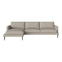Light beige sectional sofa with a smooth fabric surface and minimalist design, featuring subtle patterned cushions.