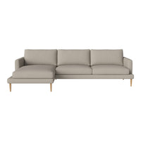 Light beige sectional sofa with a smooth texture and simple, modern design, featuring natural wood legs.