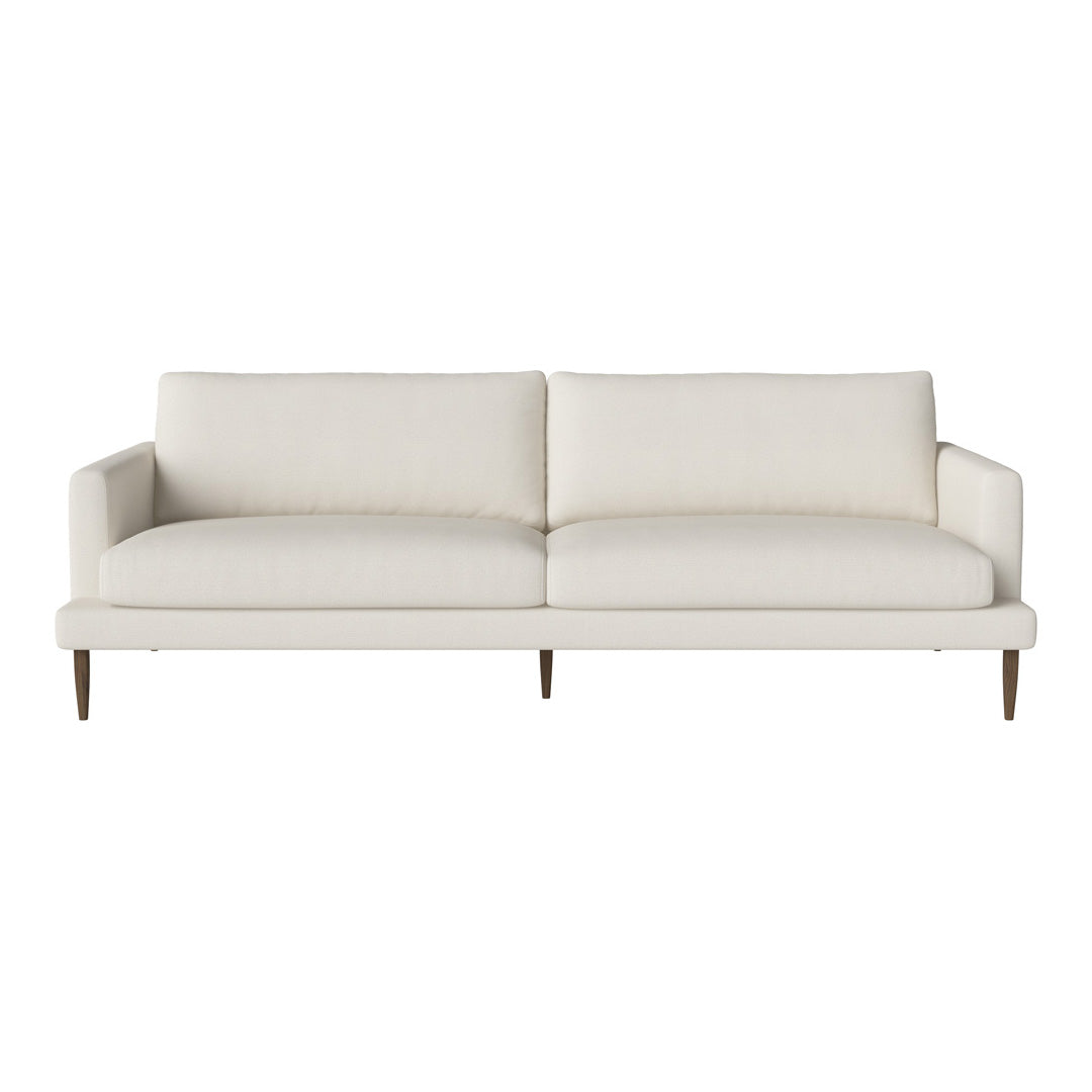 Cream-colored sofa with clean lines and minimalistic design, featuring a solid upholstery pattern and wooden legs.