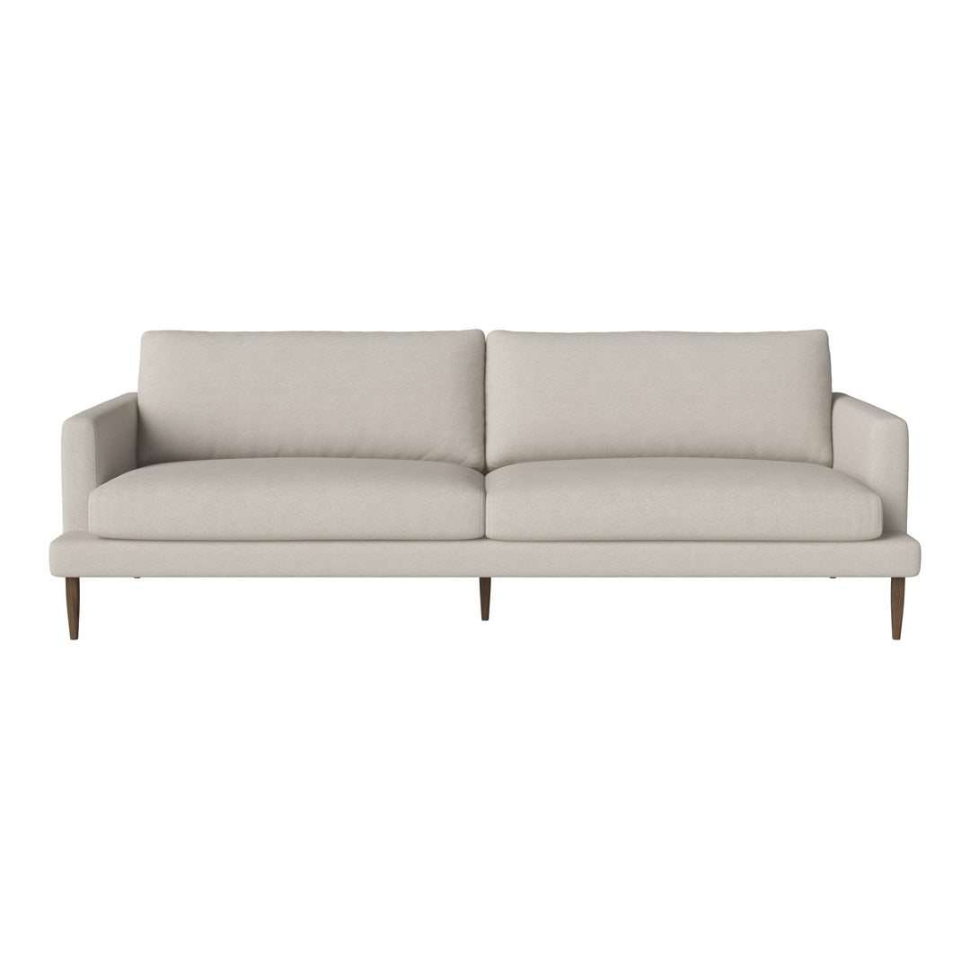 Light beige sofa with a simple, minimalist design and smooth upholstery, featuring no distinct patterns.
