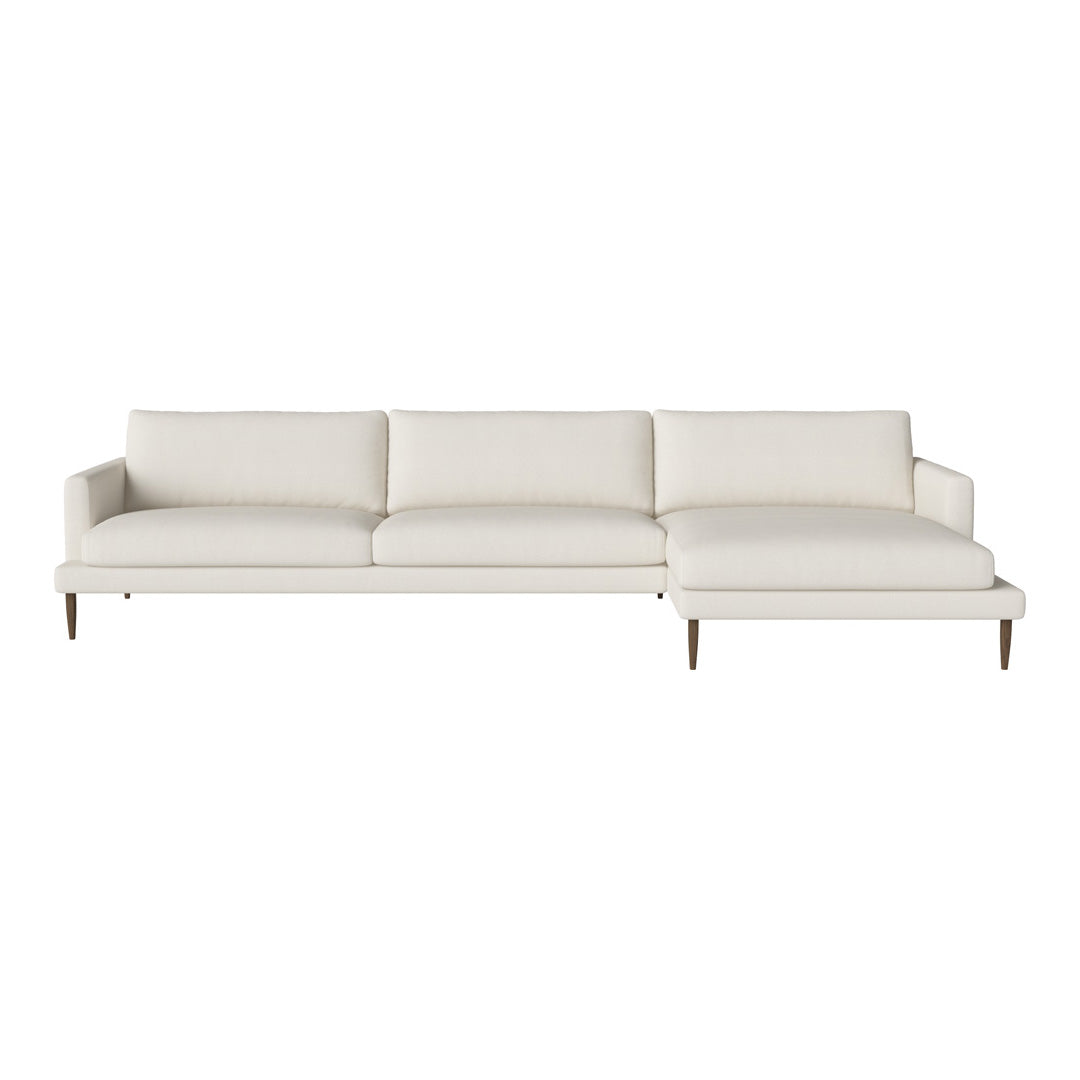 Modern white sectional sofa with clean lines and minimalistic design, featuring plush cushions and wooden legs.