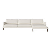 Modern white sectional sofa with clean lines and minimalistic design, featuring plush cushions and wooden legs.