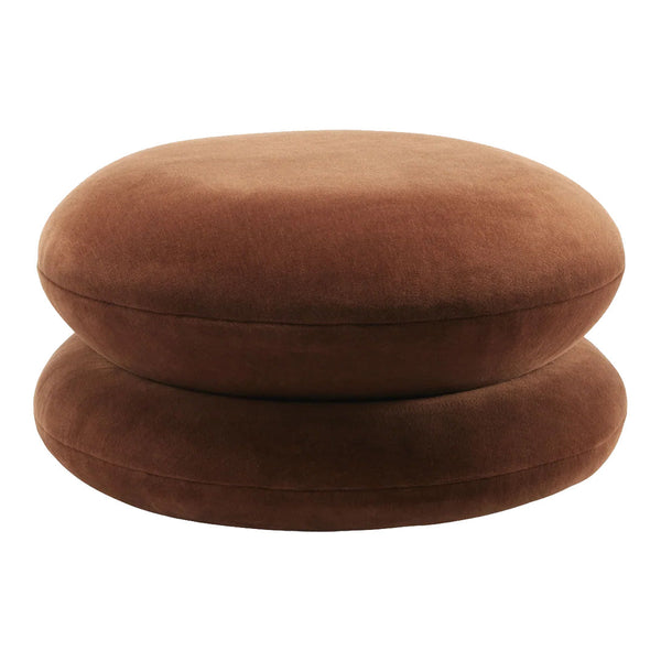 Round brown velvet cushions stacked on top of each other, featuring a soft, smooth texture.